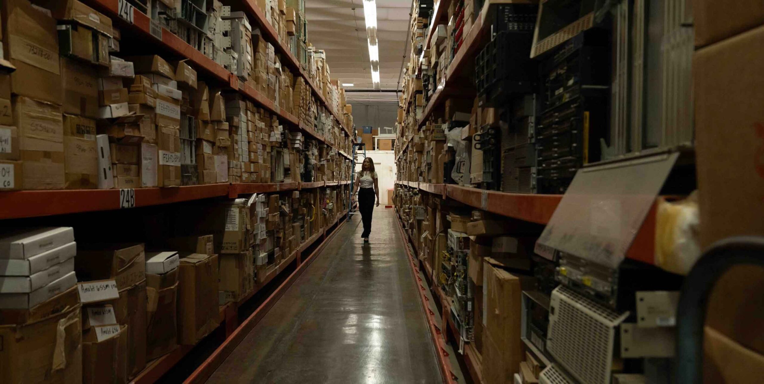 warehouse interior at United Tel Supply with employee walking